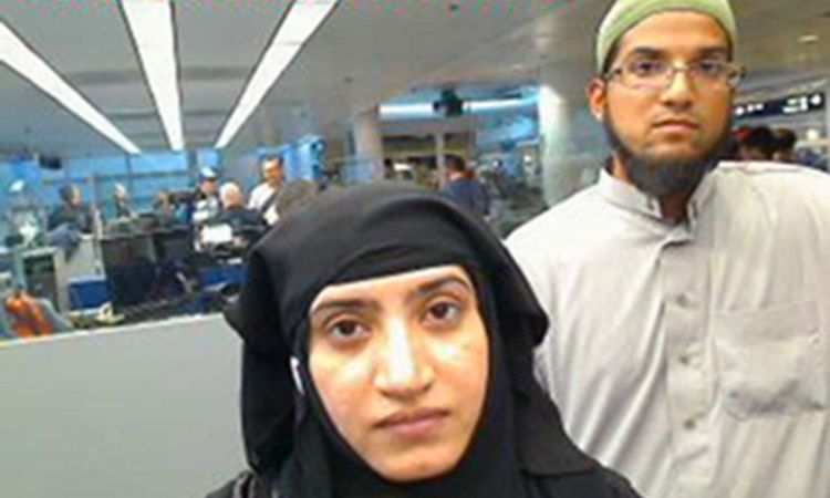 This July 27, 2014, photo provided by U.S. Customs and Border Protection shows Tashfeen Malik, left, and Syed Farook, as they passed through O'Hare International Airport in Chicago. A U.S. magistrate has ordered  Apple to supply highly specialized software the FBI can load onto a phone used by one of the shooters in the San Bernardino terrorist attack. 