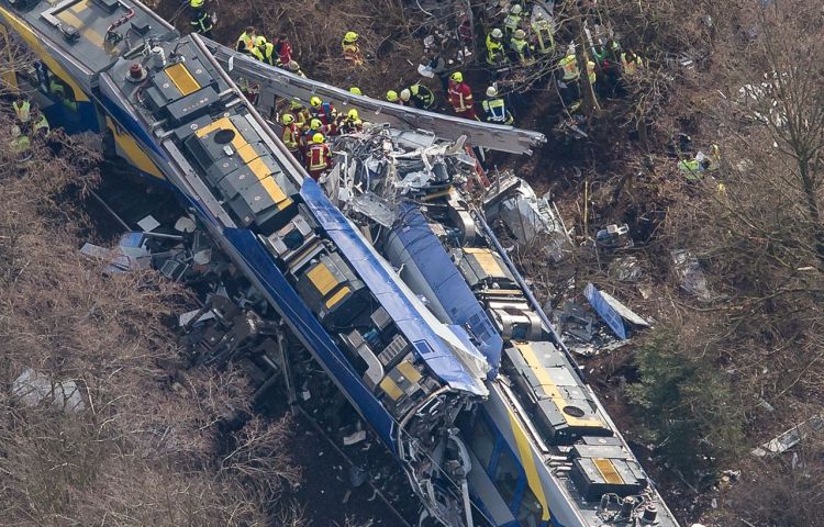 Rescue workers comb through wreckage at the site of a train collision near Bad Aibling, Germany, Tuesday. Photo by Peter Kneffel/dpa via AP