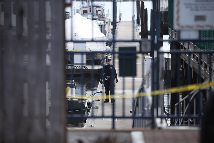 Police have crime scene tape on the Portland waterfront at DiMillo's East Marina where a body was discovered in the water. Jill Brady/Staff Photographer