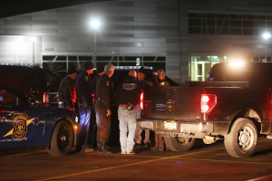 Police meet early Sunday at Kalamazoo Valley Community College after searching for a gunman involved in multiple shootings Saturday in Kalamazoo, Mich. The Associated Press/Mark Bugnaski/Kalamazoo Gazette
