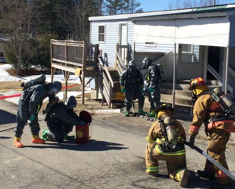 Police and firefighters prepare to enter a suspected meth lab in Livermore Falls. Courtesy Photo