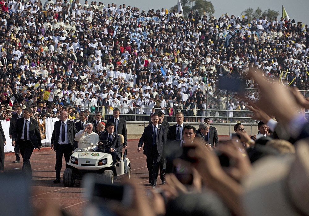 Pope Francis arrives for Mass in a golf cart at Venustiano Carranza stadium in Morelia, Mexico, Tuesday. On his to the capital of troubled Michoacan state, the Pope will also meet with youth and pay a visit the Morelia cathedral. The Associated Press