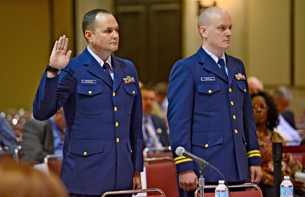 Petty Officer 2nd Class Matthew Chancery, left, is sworn in to start the day while standing next to his counsel, Lt. Travis Noyes,  as a Coast Guard hearing into the sinking of the El Faro continues in Jacksonville, Fla., Wednesday.
Bob Mack/The Florida Times-Union via AP