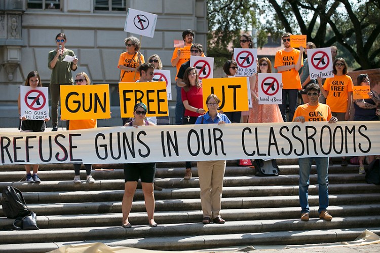 In this October, 2015 photo, protesters gather on the West Mall of the University of Texas campus to oppose a new state law that expands the rights of concealed handgun license holders to carry their weapons on public college campuses.