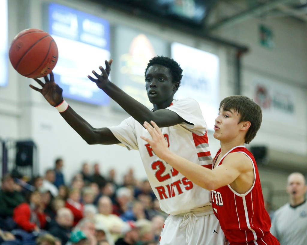 Ruay Bol of South Portland passes to a teammate while being defended tightly by Ethan Belanger of Sanford during the fourth quarter.
Derek Davis/Staff Photographer