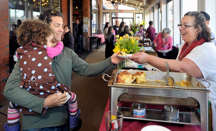 In this 2012 photo, Andrew Tenenbaum of Portland, gets a serving of Creme Brulee French Toast from Lisa Kostopoulos, owner/executive Chef of the Good Table Restaurant in Cape Elizabeth at the Incredible Breakfast Cook-Off held at Sea Dog Brewing Co. in South Portland that traditionally kick-starts Maine Restaurant Week.