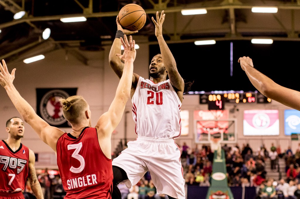 Red Claws guard Levi Randolph drives around Rapters 905 forward E.J. Singler for a basket in the final seconds of the first half. 