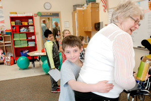Duncan Blanchard hugs his grandmother Rosanne Mapp after she brought a frog cut out of a watermelon to his classroom at Kennebunk Elementary School to celebrate Duncan's leap-year birthday. Gregory Rec/Staff Photographer