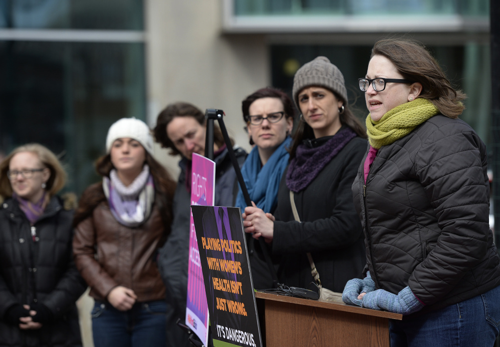 Kate Grogan, far right, of Maine Family Planning in Augusta speaks during Wednesday's rally at Monument Square in Portland.