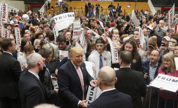 Republican presidential candidate Donald Trump signs autographs during a rally at Radford University in Radford, Va., on Monday. He has won 10 of the 15 primary contests so far, but falls short of the majority of delegates needed to win the Republican nomination.
