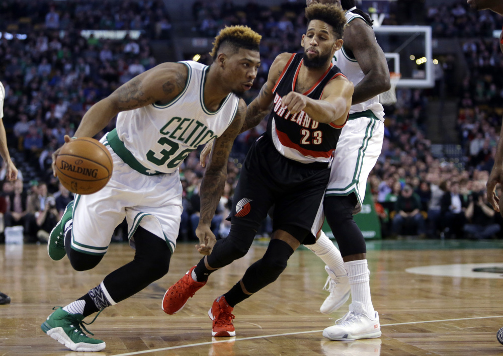Celtics guard Marcus Smart drives on Portland Trail Blazers guard Allen Crabbe in the first quarter Wednesday night in Boston.