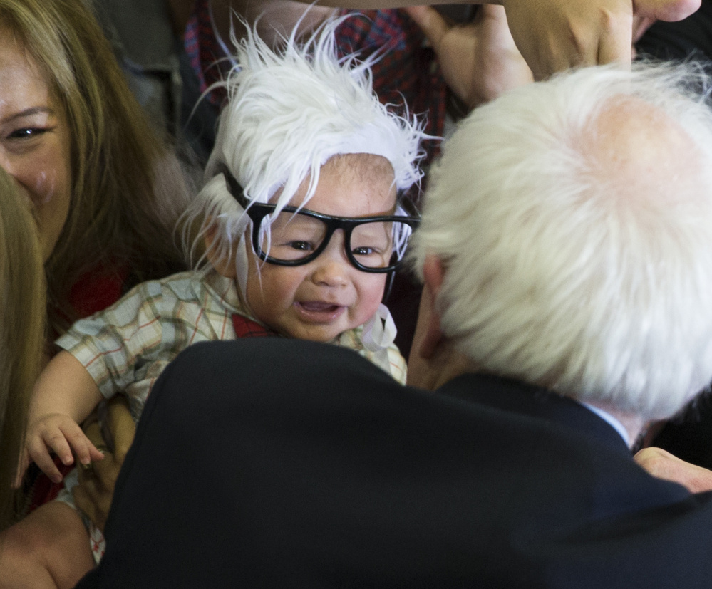 Oliver Jack Carter Lomas-Davis, then 3 months old, comes face-to-face with Sen. Bernie Sanders last month.  The cheerful infant, known as Bernie Baby, died Feb. 25.