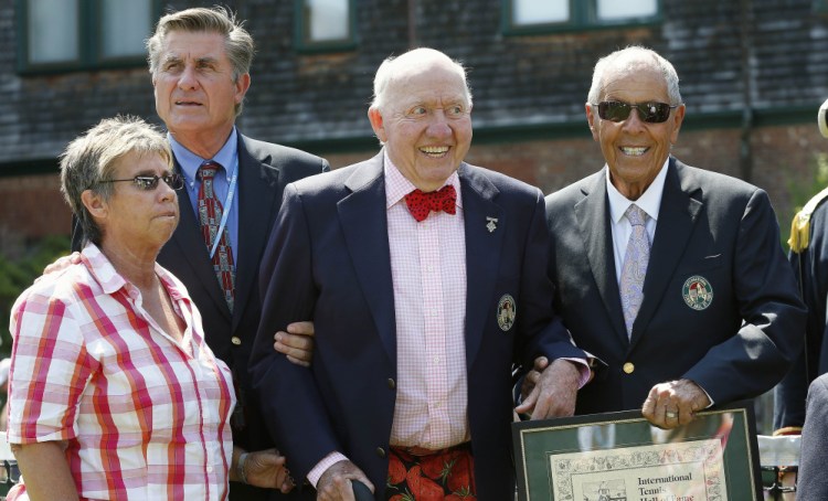 Bud Collins, center, is inducted into the International Tennis Hall of Fame in 2014 in Newport, R.I. With him are fellow inductees, from left, Rosie Casals, Charlie Pasarell and Nick Bollettieri.