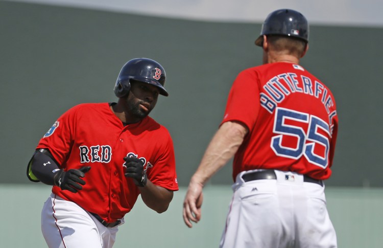 Jackie Bradley Jr. of the Boston Red Sox greets third-base coach Brian Butterfield while rounding the bases Friday after hitting a solo home run in the third inning of a 7-2 victory against the Tampa Bay Rays.