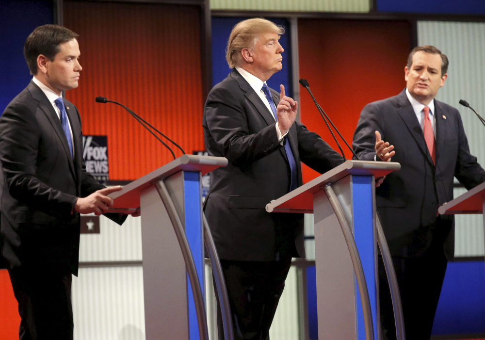 Donald Trump gestures between Florida Sen. Marco Rubio, left, and Texas Sen. Ted Cruz during the Republican presidential candidates’ debate in Detroit on Thursday.