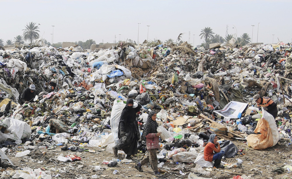 Iraqis search for recyclables at a Baghdad dump where most workers are widows and orphans living further and further below a lengthening poverty line.