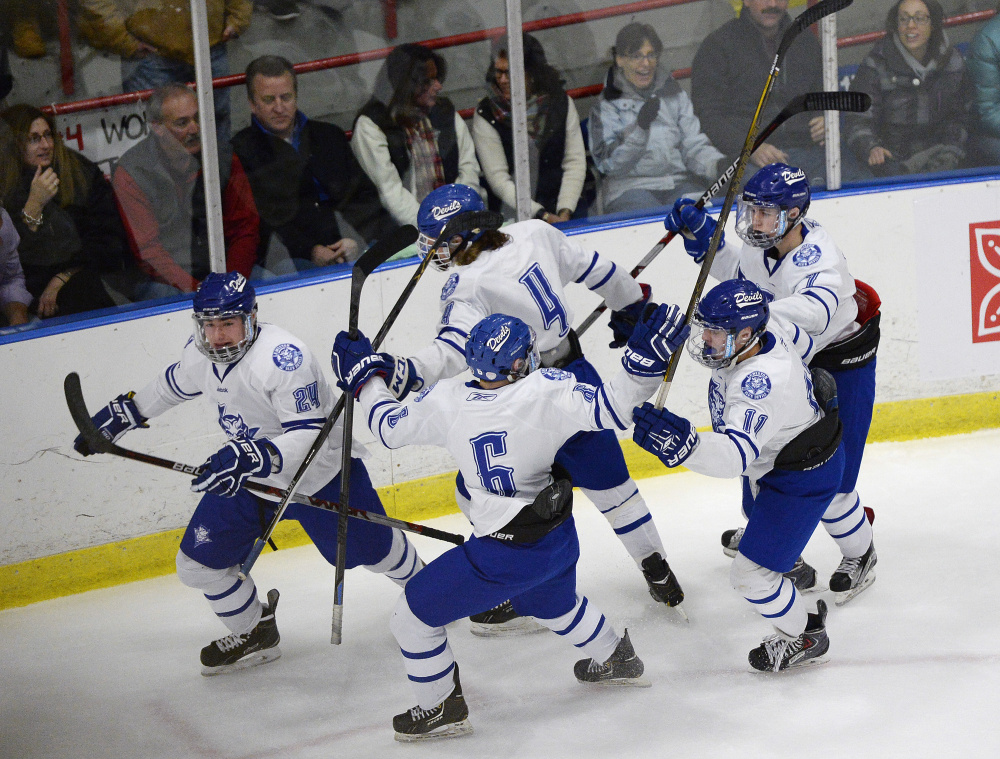 Lewiston players celebrate and early goal by Joe Bisson in the Class A boys’ hockey state championship game Saturday night. Lewiston got a last-minute goal to beat defending champion Scarborough, 2-1.