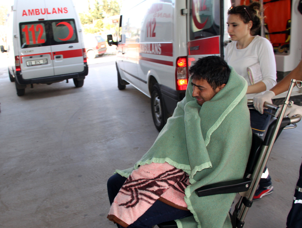 Medics care for a rescued migrant at a hospital in Didim, Turkey, on Sunday. Turkey’s state-run news agency said 25 migrants drowned off Turkey while trying to reach Greece.