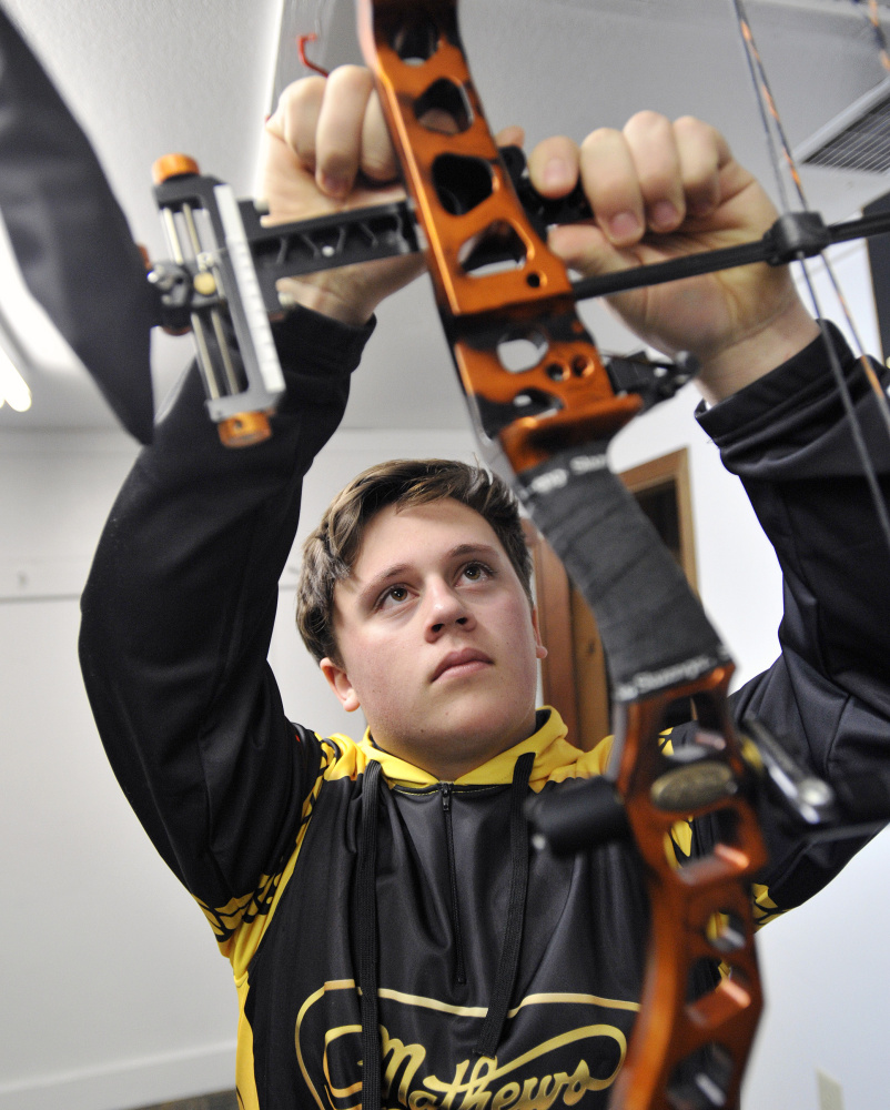 Malcolm Bourgeois makes adjustments to his bow.
Shawn Patrick Ouellette/Staff Photographer