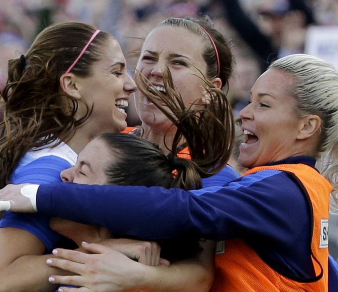U.S. forward Alex Morgan, top left, celebrates with teammates after scoring the winning goal against France.