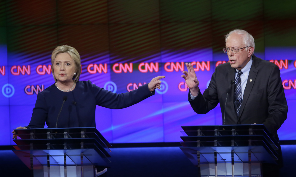Democratic presidential candidates Hillary Clinton and, Sen. Bernie Sanders, I-Vt., argue a point during a Democratic presidential primary debate at the University of Michigan-Flint on Sunday.
