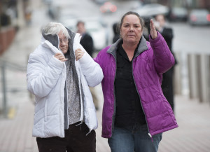 Philip Scott Fournier’s mother, left, and sister leave the court house in Bangor after Fournier made his first appearance on a homicide charge.