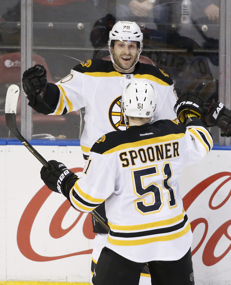 Bruins right wing Lee Stempniak and center Ryan Spooner celebrate after Stempniak’s game-winning goal in overtime. The Bruins defeated the Panthers, 5-4, in a key Atlantic Division game.