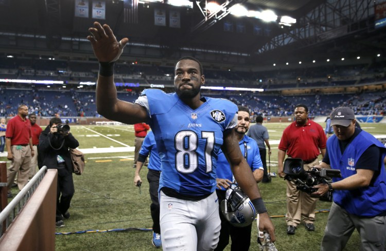 In this Nov. 9, 2014, file photo, Detroit Lions wide receiver Calvin Johnson waves to fans after defeating the Miami Dolphins 20-16 in a NFL football game in Detroit.