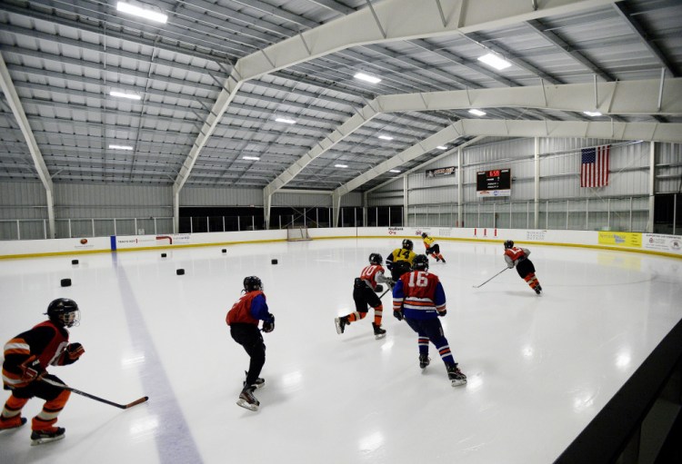 Players skate around the Casco Bay Arena in Falmouth, which opened in October. The added ice time in the Portland area is a boon for many players.