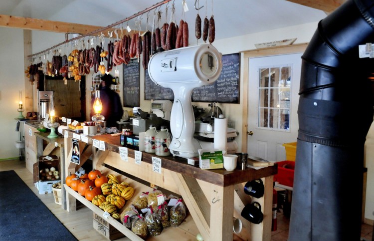 Smoked meats and cheeses and fresh vegetables are offered at the Charcuterie shop in Unity. The owner is working with state regulators to comply with food codes, a challenge because of the lack of electricity and technology at the shop.