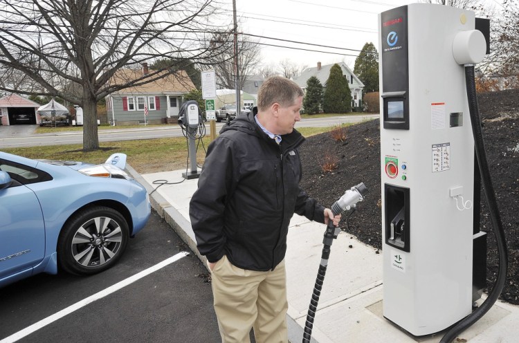 South Portland City Manager Jim Gailey checks out the high-speed charging station as he recharges his department’s new Nisson Leaf at a slower charging station at the South Portland Community Center. Maine is working with Quebec to develop a corridor of electric car charging stations.