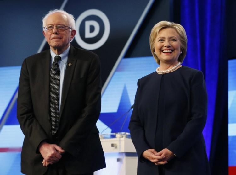 Democratic presidential candidates, Hillary Clinton and Sen. Bernie Sanders, I-Vt,  stand together before the start of the Univision, Washington Post Democratic presidential debate at Miami-Dade College,  Wednesday, in Miami, Fla.