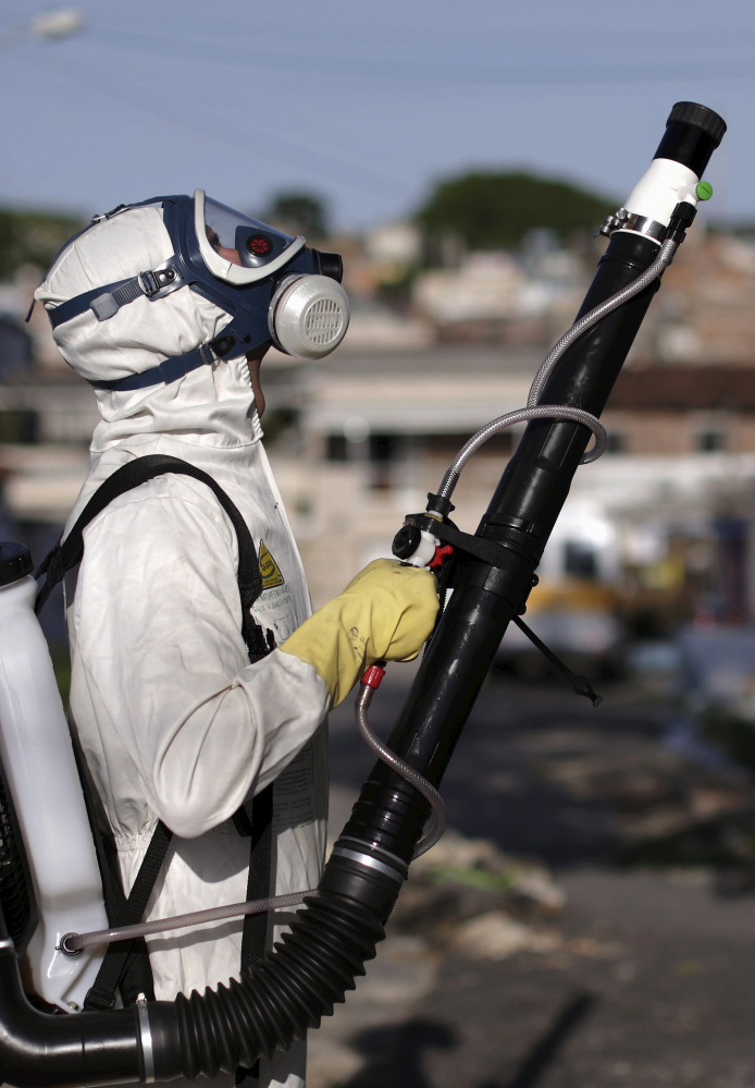 A worker sprays insecticide in Recife, Brazil, in an effort to fight the Zika virus, which is spread by mosquitoes.