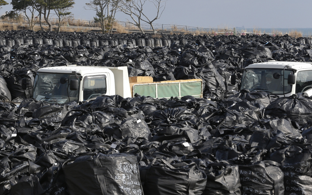 Trash bags filled with collected radioactive materials are packed at a temporary waste storage site in Tomioka, Fukushima prefecture, northeastern Japan. Some 7,000 day laborers are cleaning up the irradiated town.