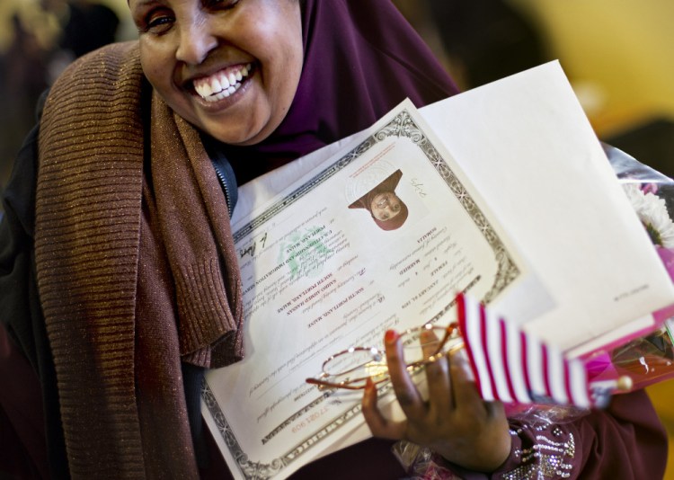 Sahro Hassan, 46, of South Portland, originally from Somalia, smiles after receiving her certificate of U.S. citizenship following a ceremony in Portland on Friday.