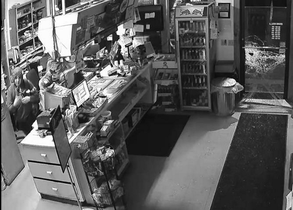 One of three burglars who broke into the Flying Point Variety store in Mount Vernon on Thursday is shown at left. The trio broke the door at right to get in.