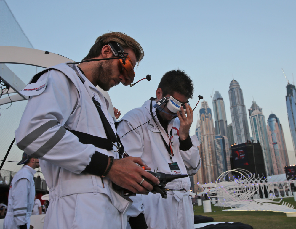 Fill Freybott, pilot of Freybott team of Germany, left, controls the team’s drone during the first World Drone Prix in Dubai, United Arab Emirates, on Saturday.