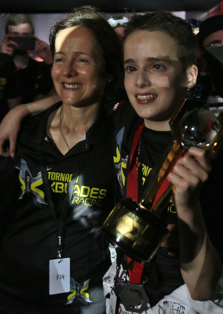 Luke Bannister, 15, of Somerset, England, with his mother, holds the first-prize trophy that he led his team to win.
