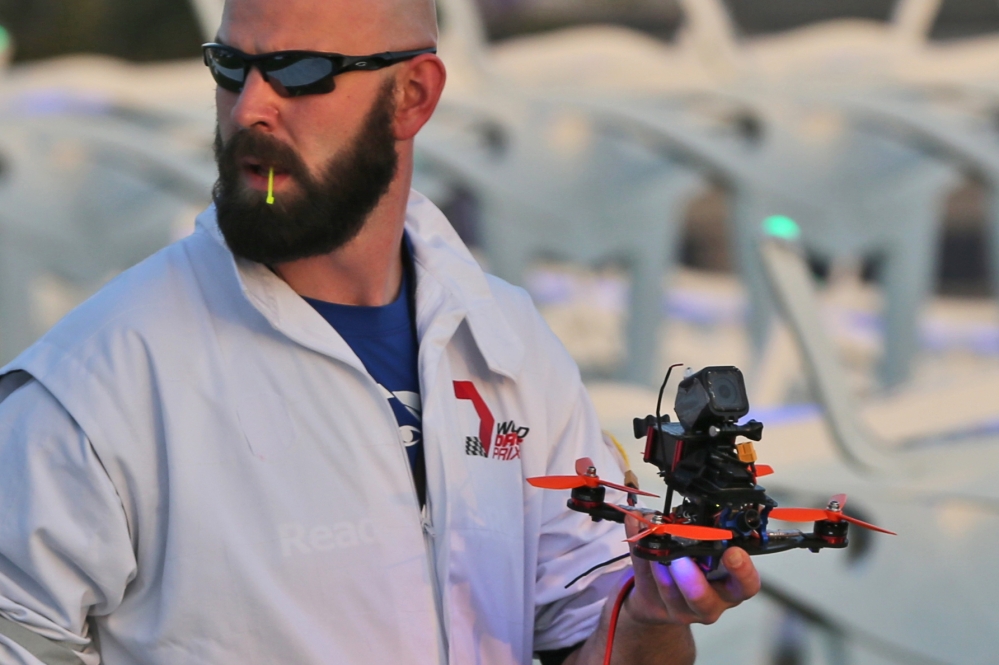 A team member carries a drone during the final day of the first World Drone Prix in Dubai, United Arab Emirates, on Saturday.