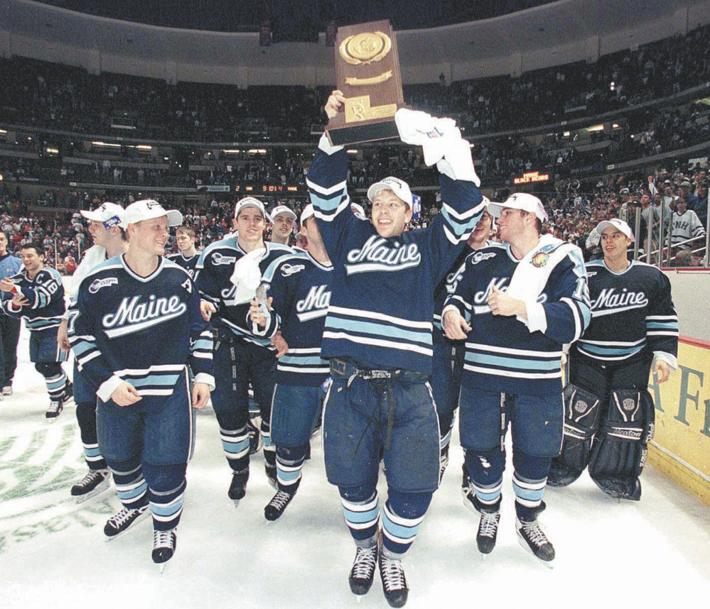 In the glory days of the University of Maine’s hockey program, Marcus Gustafsson, who scored the game-winning goal in the NCAA Division I championship game in 1999, is surrounded by teammates as he hoists the trophy in Anaheim, Calif.