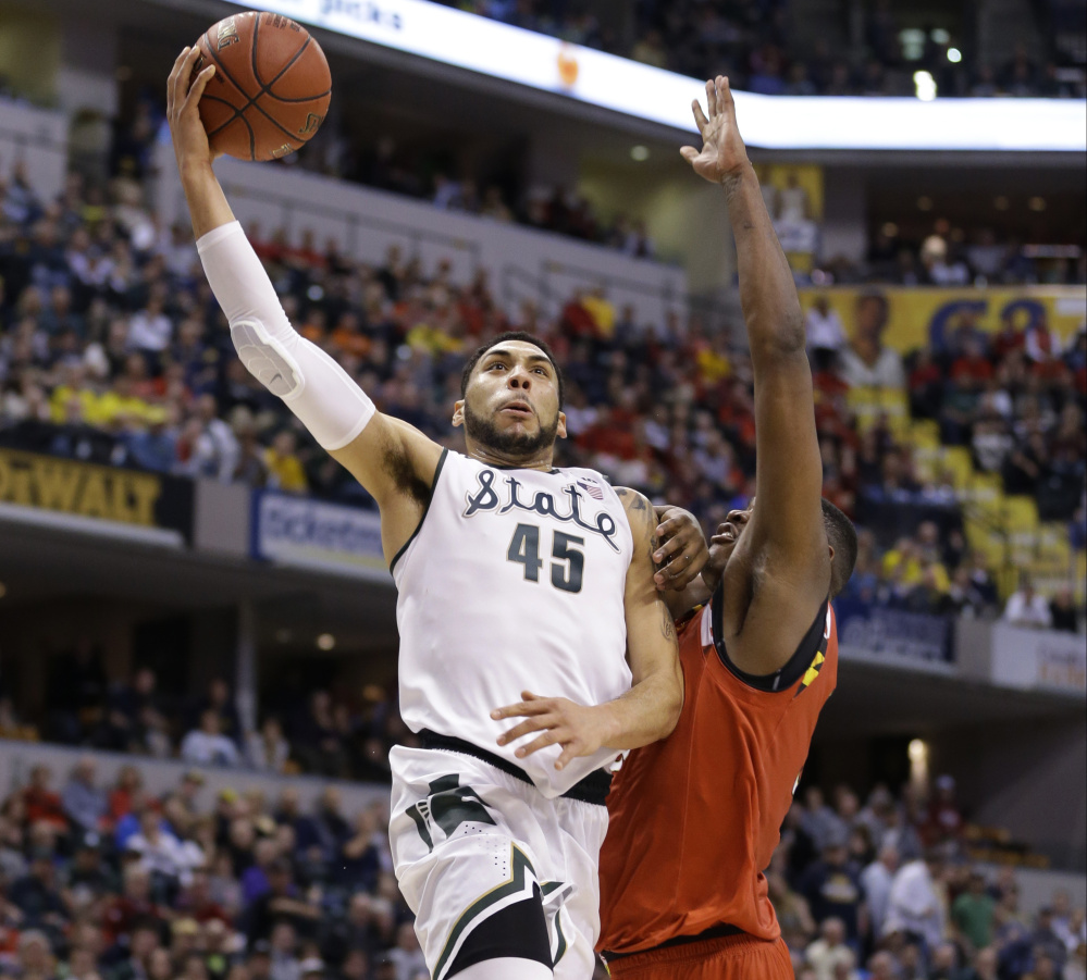 Michigan State’s Denzel Valentine hits for two points against Maryland’s Diamond Stone during a 64-61 win by the Spartans in the semifinals of the Big Ten Conference tournament at Indianapolis on Saturday.