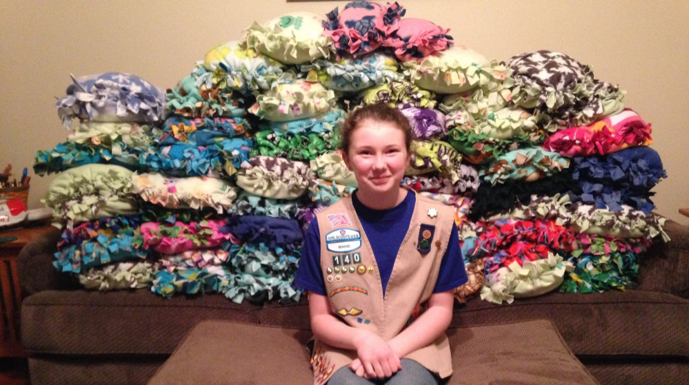 Gabrielle Bruns, a member of Girl Scout Troop No. 140 of Buxton, with the 64 pillows that were created for a “Pillows for Patients” campaign she oversaw as part of a scouts community service project.