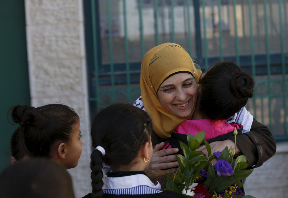 Palestinian teacher Hanan al-Hroub is hugged by a student in the West Bank city of Ramallah.
