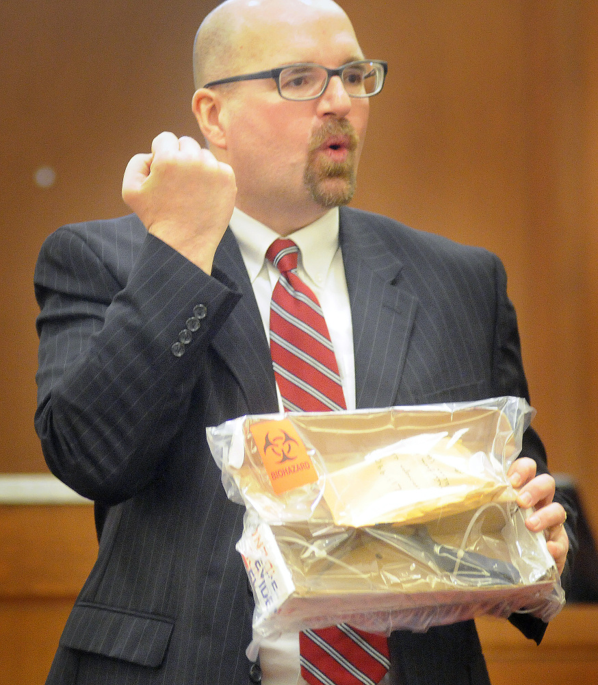 Assistant Attorney General Donald Macomber describes how Jones died from wounds made by a knife that he is holding during opening arguments Monday.