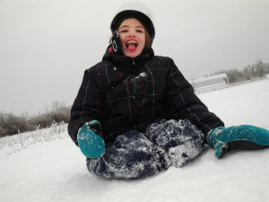 Cyndimae Meehan slides in the snow shortly after moving to Maine. Her epilepsy left her “a shell of a child” before cannabis treatment allowed her to run, laugh and swim.