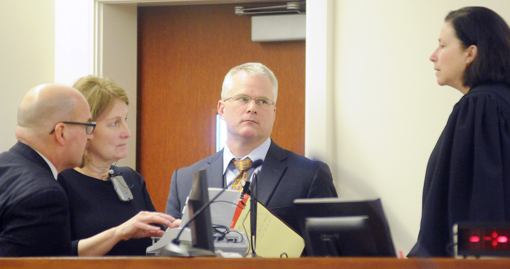 Superior Court Justice Michaela Murphy, right, holds a sidebar conference with prosecution and defense attorneys during the opening arguments of the murder trial of Justin Pillsbury on Monday.