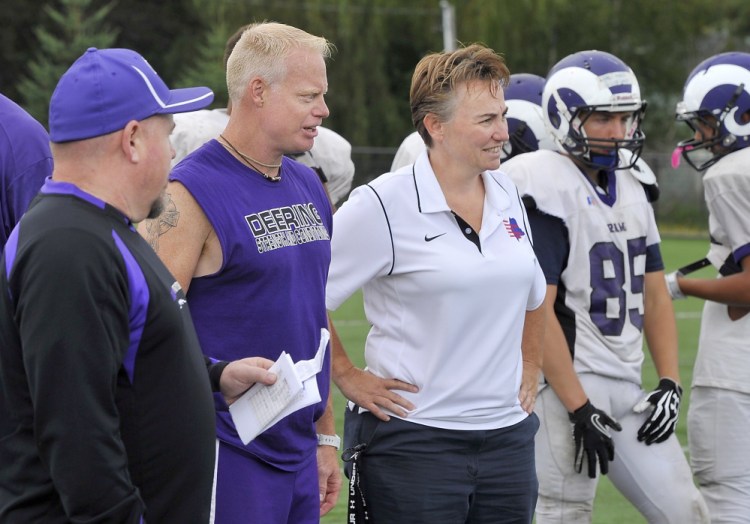 Melanie Craig, Deering High School's athletics administrator, talks to coaches at a football practice in August. Her testimonial on school letterhead was an innocent mistake, officials say.
