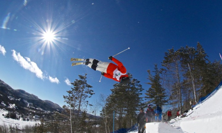 Alex Jenson twists in midair during a moguls run at Val Saint-Come in Quebec on Feb. 27.