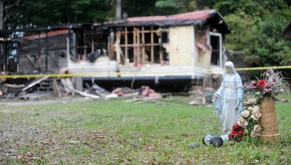 A neighbor has been charged with setting the fire that destroyed this mobile home at 289 Brown’s Corner Road in Canaan and killed four dogs and three cats.