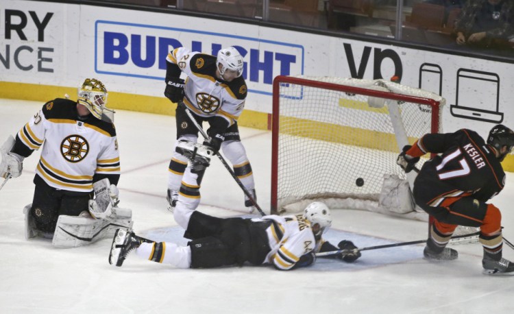 Anaheim center Ryan Kesler slaps in a goal as Bruins goalie Jonas Gustavsson is caught out of position and defenseman Dennis Seidenberg dives for the puck in the first period of Friday night’s game in Anaheim, Calif.